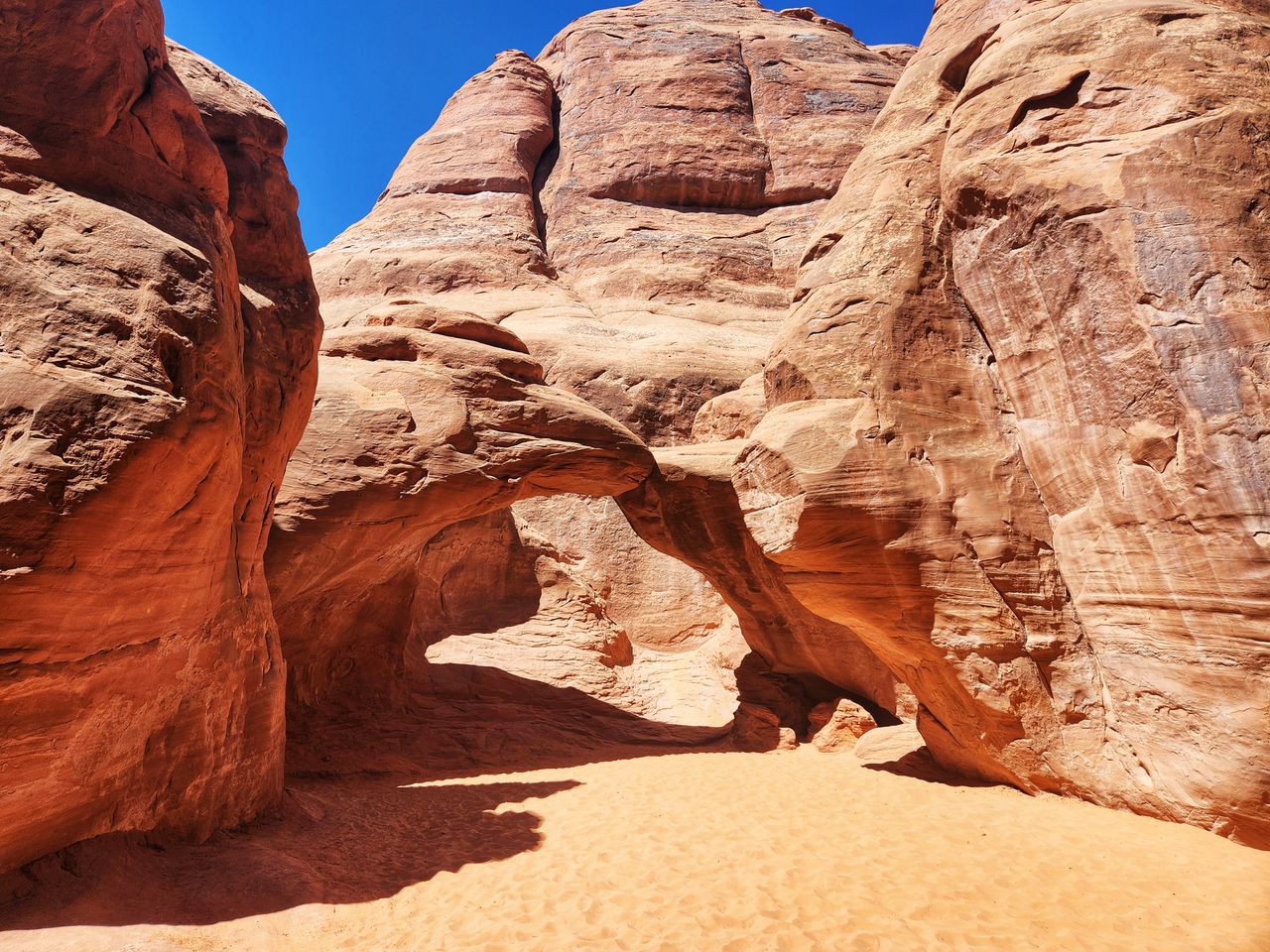 Explore the iconic rock formations of Arches National Park, Moab, Utah, under a clear blue sky.
